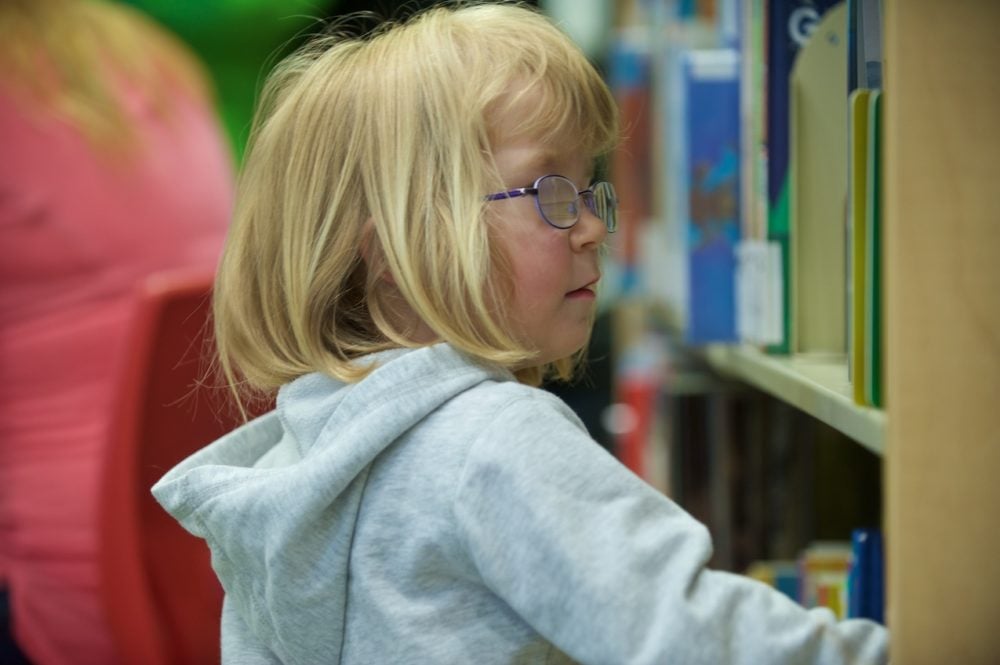 child searching a library