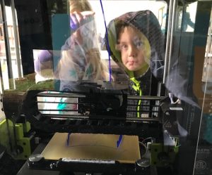 Child watching 3D printer